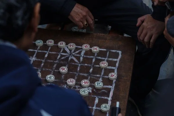 asian man playing board game